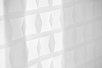 Nahaufnahme des weissen MHZ Doppelrollos „Oskar“ mit geometrischem Muster aus transparenten und blickdichten Flächen.