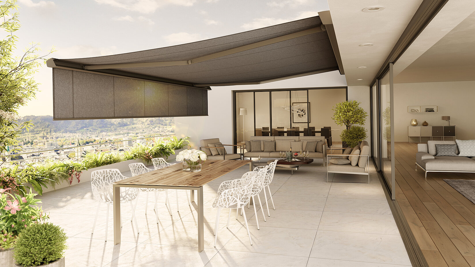 Anthrazitfarbene Markise mit Volant an der vorderen Kassette über stilvoll möblierter Terrasse.