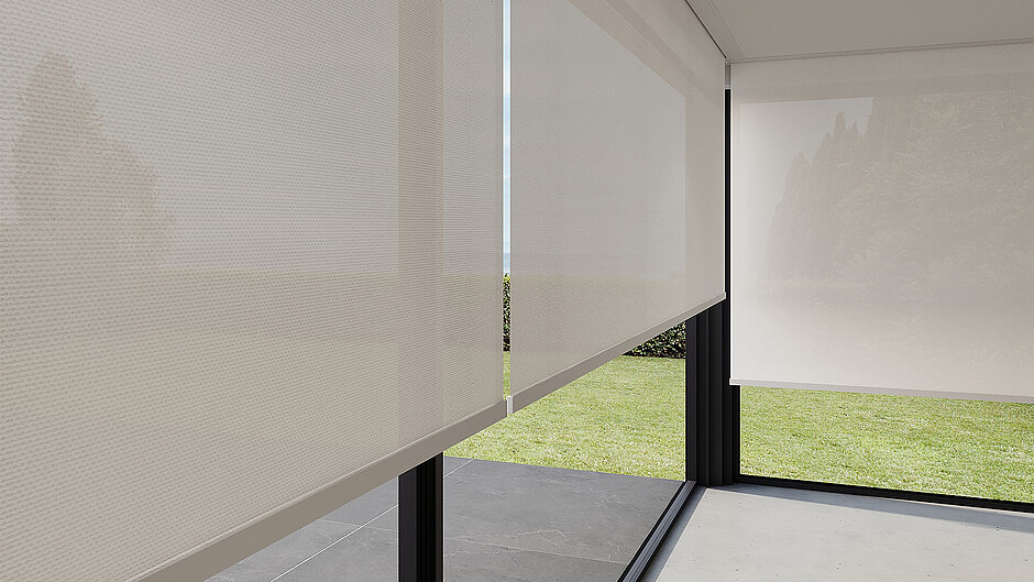 Detailansicht halbtransparenter Rollos mit feinem Gewebe vor grossen Glasflächen mit Ausblick ins Grüne