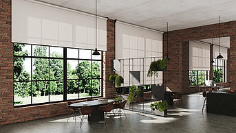 Industrielles Loft mit grossen Sprossenfenstern und lichtdurchlässigen Rollos. Ziegelwände, Betonoptik und moderne Einrichtung sorgen für urbanen Charme.